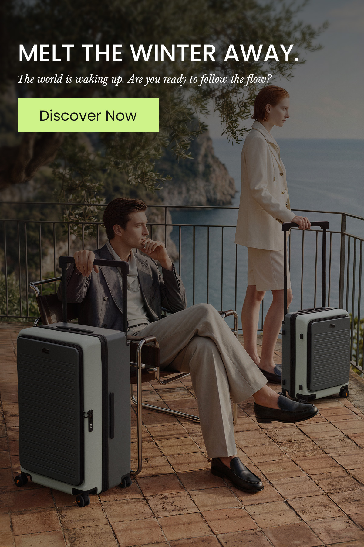A man and woman traveling with LEVEL8 Voyageur luggage on a scenic Mediterranean balcony. Text: Melt the winter away. The world is waking up. Are you ready to follow the flow?
